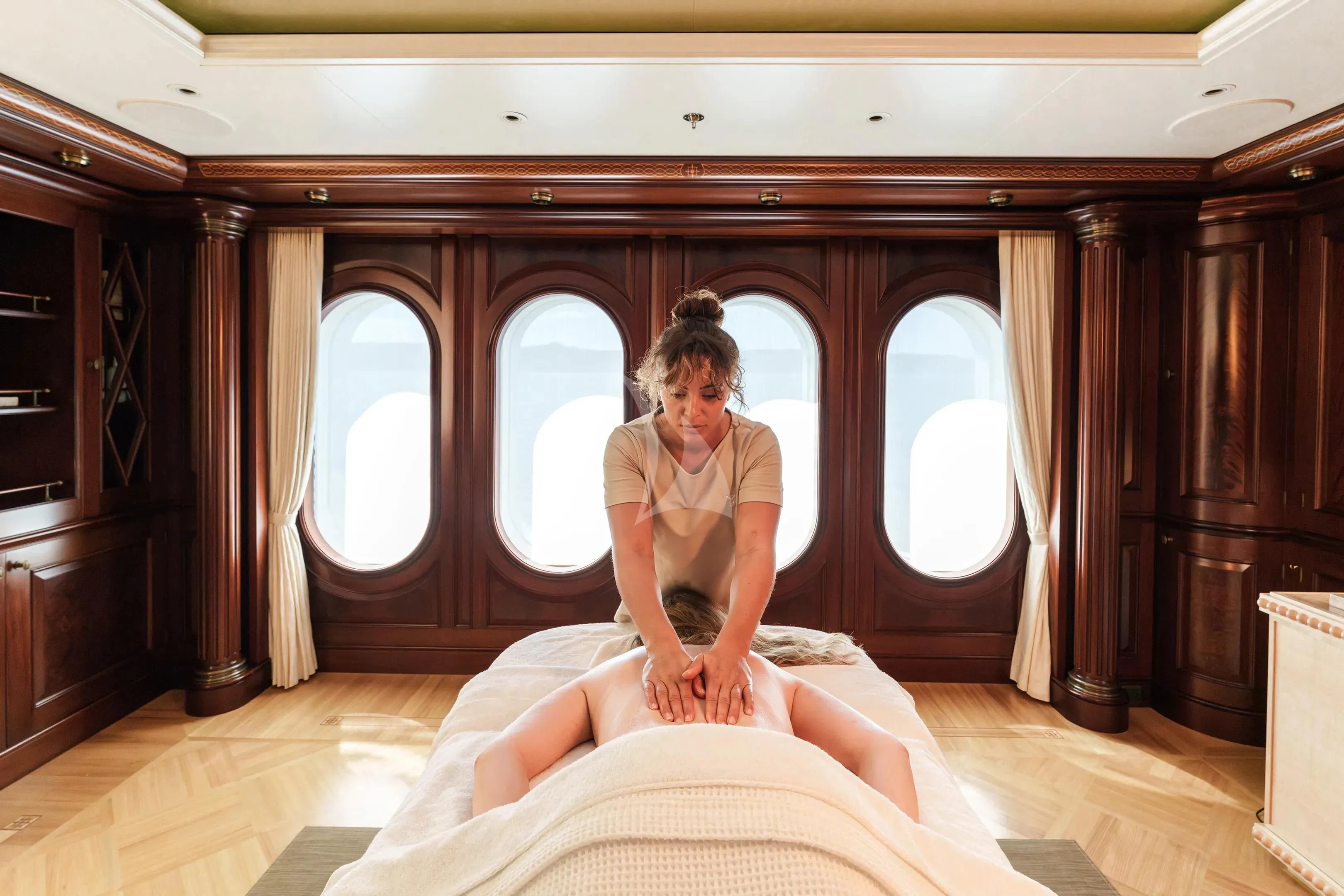 a person sitting on a bed aboard FIREBIRD Yacht for Charter