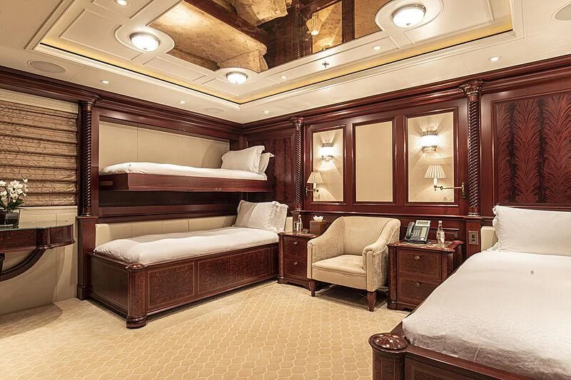 a room with a bed and a chair aboard FIREBIRD Yacht for Charter