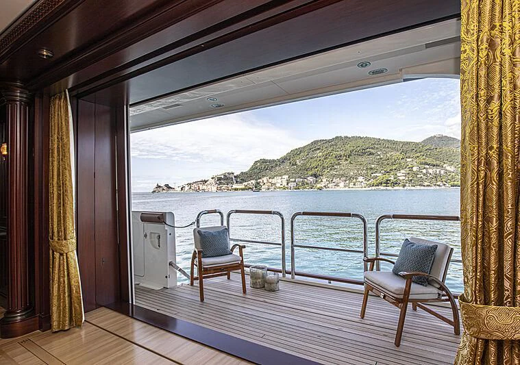 a deck with chairs and a view of the ocean aboard FIREBIRD Yacht for Charter
