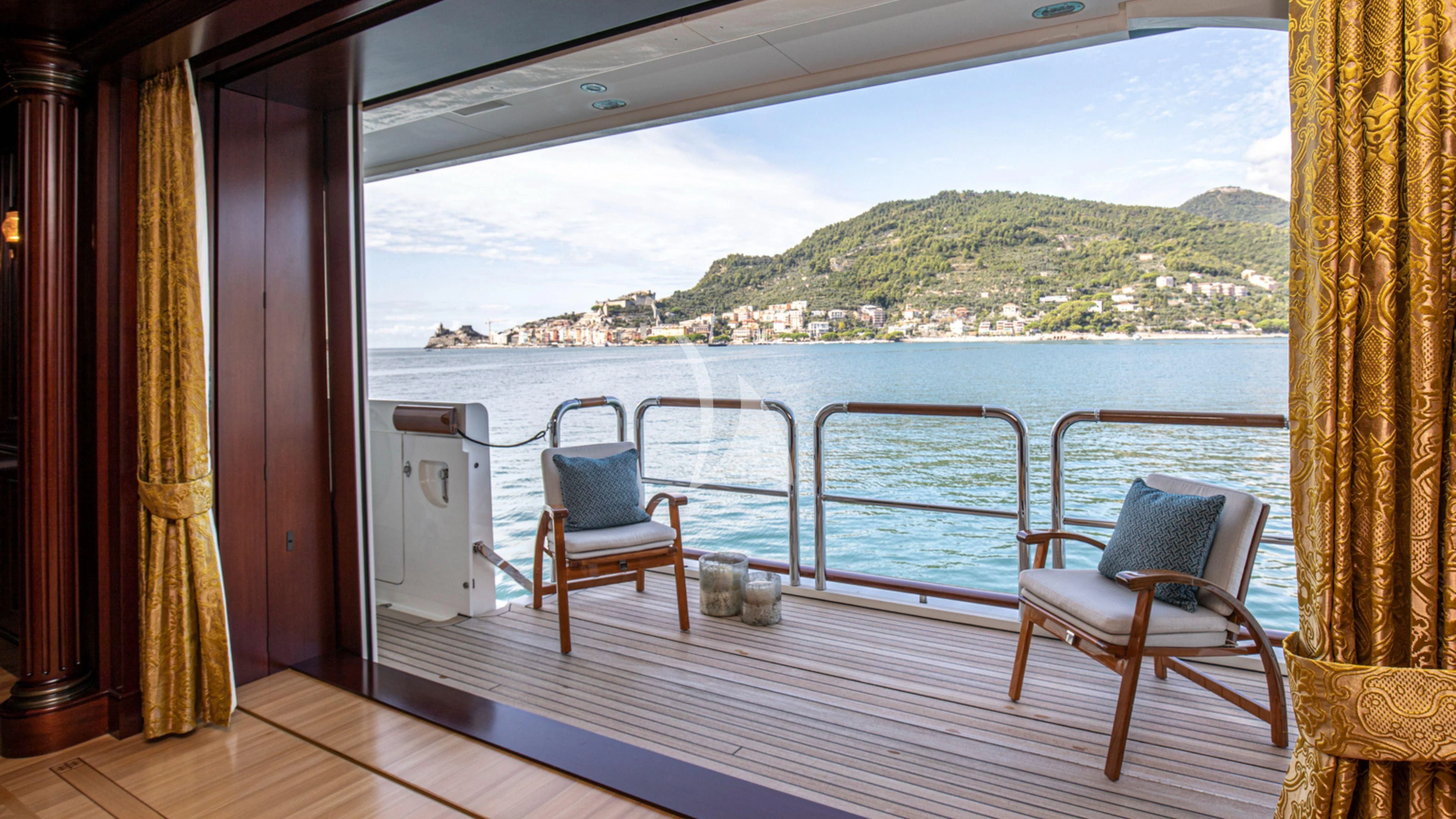 a room with a view of the ocean and a city aboard FIREBIRD Yacht for Charter