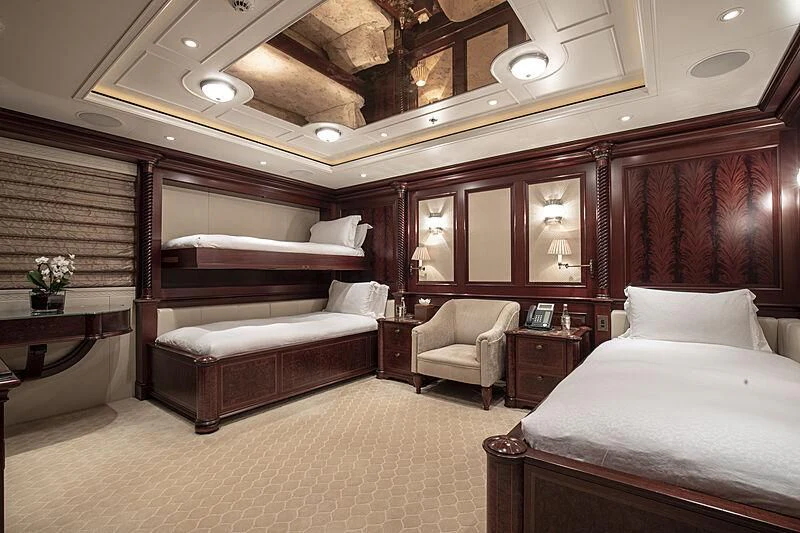 a room with a bed and a couch aboard FIREBIRD Yacht for Charter
