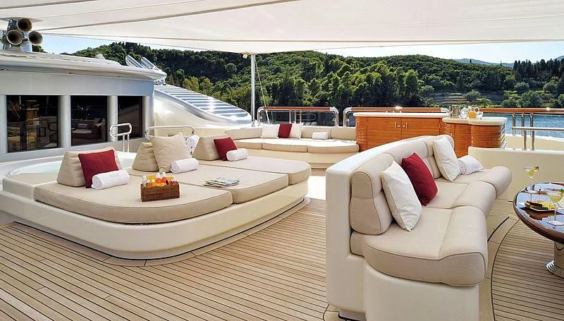 a living room with a couch and a table aboard FIREBIRD Yacht for Charter