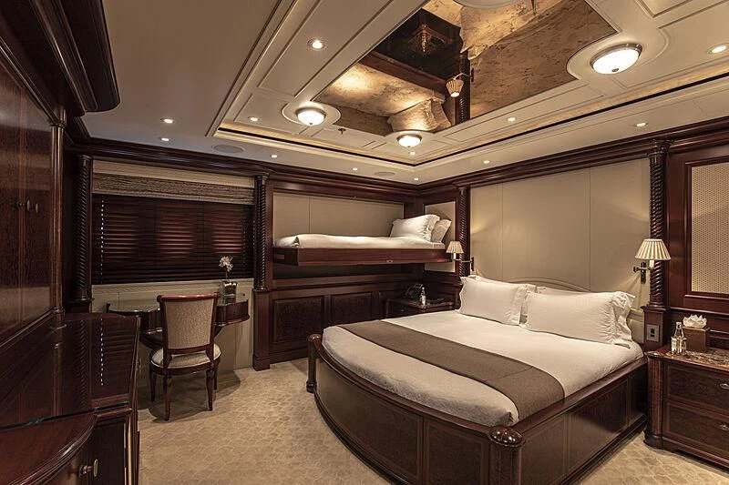a room with a bed and a chair aboard FIREBIRD Yacht for Charter