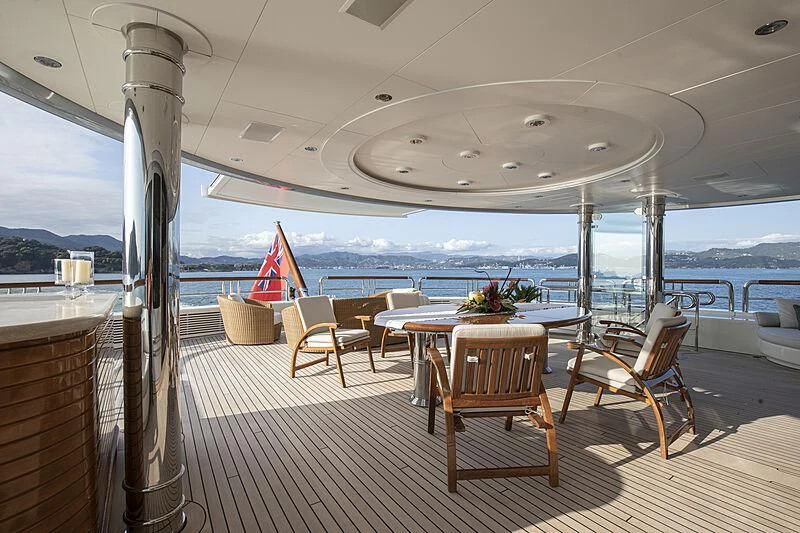 a room with tables and chairs aboard FIREBIRD Yacht for Charter