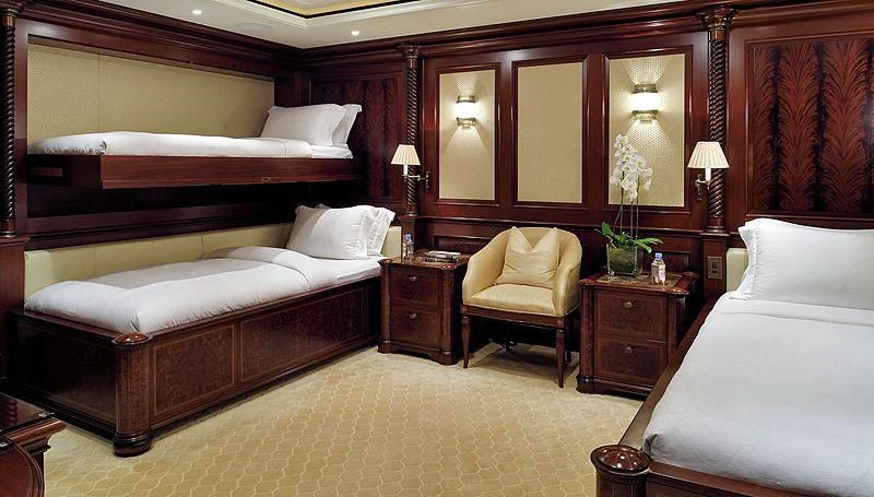 a room with a bed and a chair aboard FIREBIRD Yacht for Charter