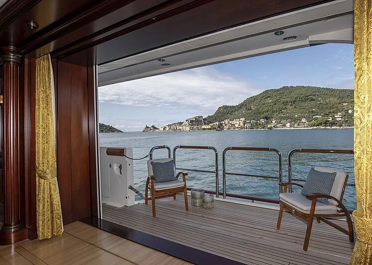a deck with chairs and a view of a city aboard FIREBIRD Yacht for Charter