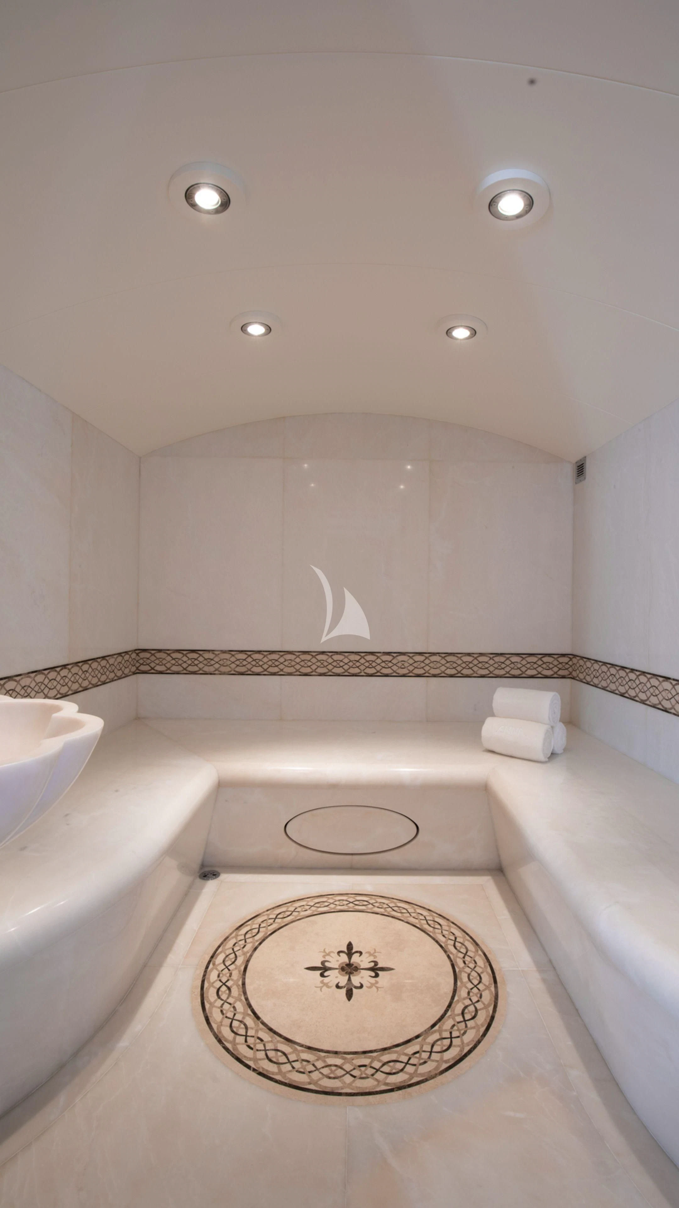 a bathroom with a sink and a rug aboard FIREBIRD Yacht for Charter