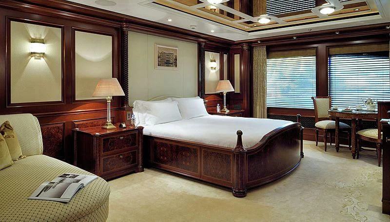 a large bedroom with a bed and a desk aboard FIREBIRD Yacht for Charter