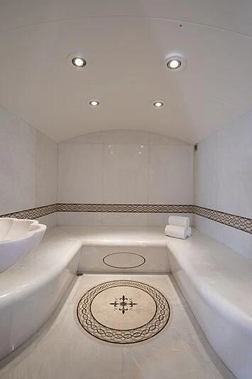 a bathroom with a rug aboard FIREBIRD Yacht for Charter