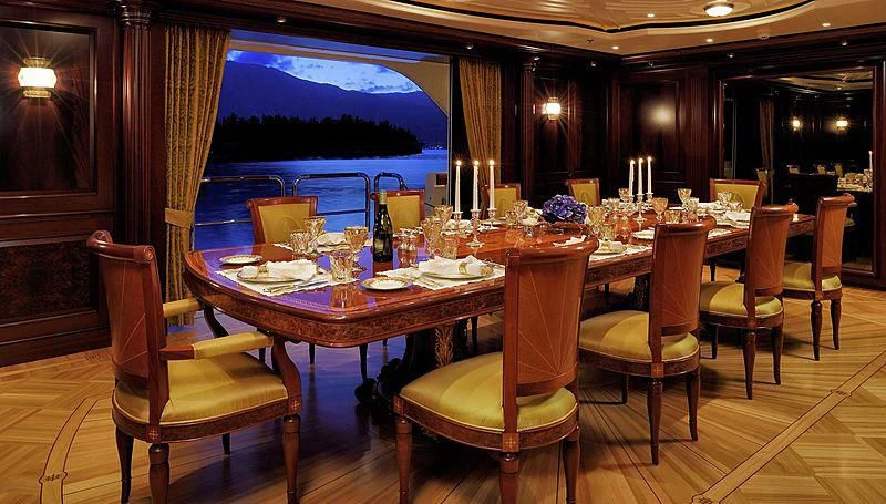 a table set with candles and flowers aboard FIREBIRD Yacht for Charter
