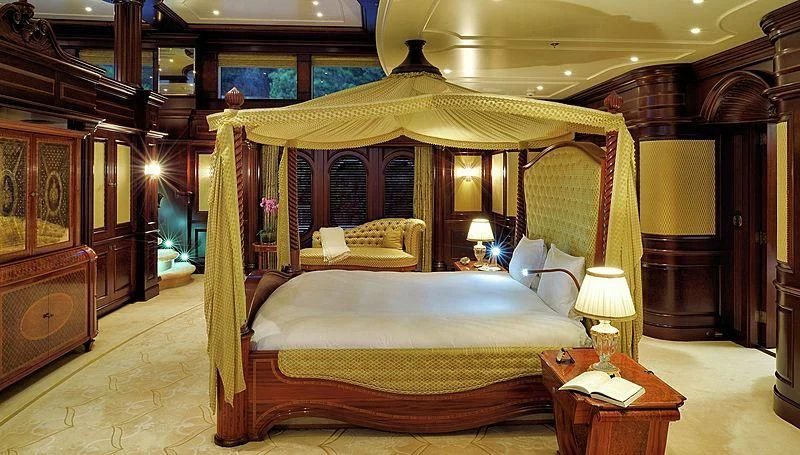 a bedroom with a bed and a desk aboard FIREBIRD Yacht for Charter