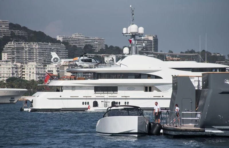 a large white ship docked aboard FIREBIRD Yacht for Charter