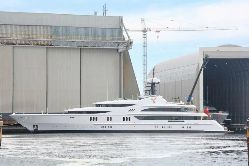 a white yacht in front of a building aboard FIREBIRD Yacht for Charter