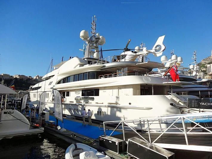 a large white boat with a helicopter on top aboard FIREBIRD Yacht for Charter