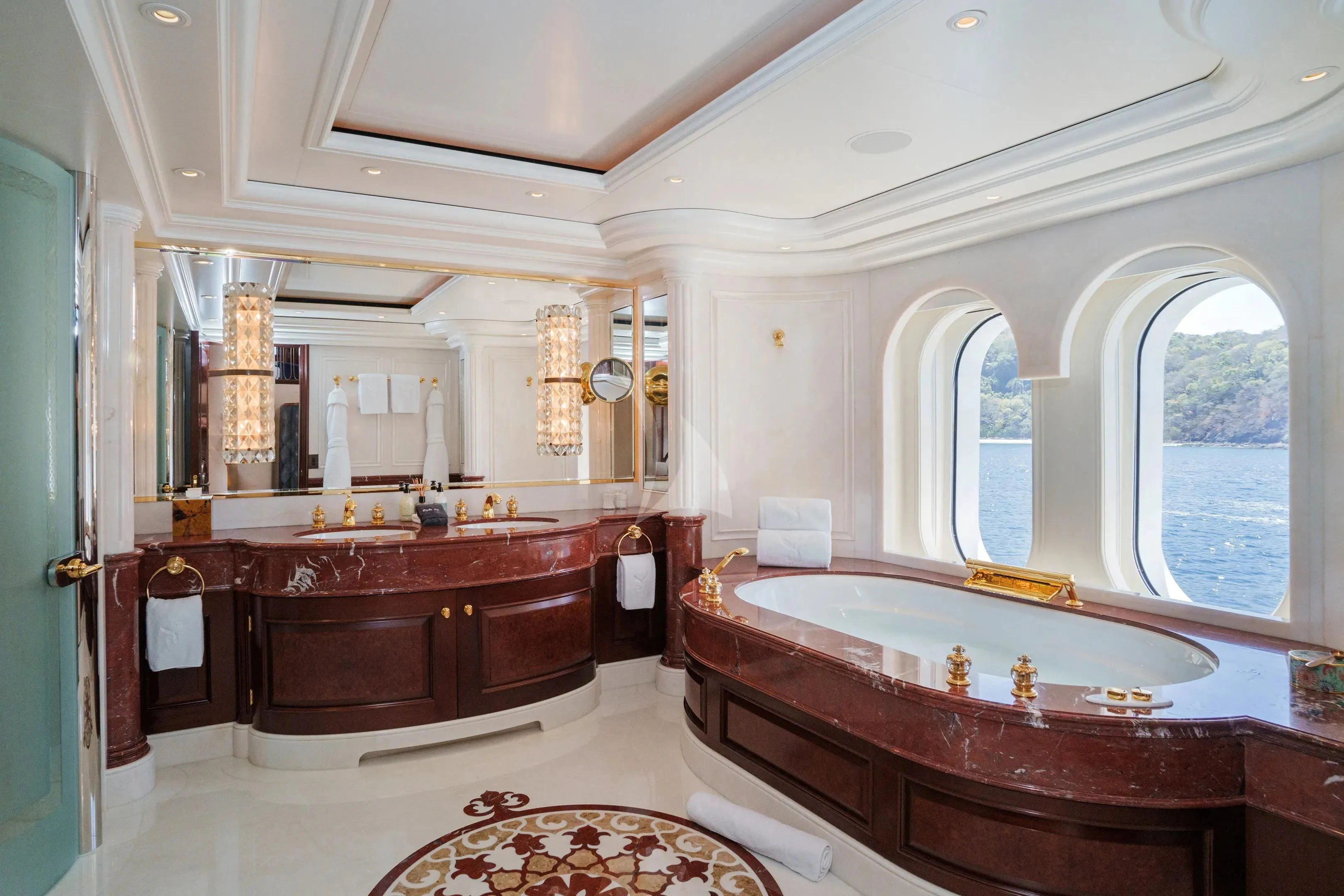 a bathroom with a tub sink and a sink aboard FIREBIRD Yacht for Charter