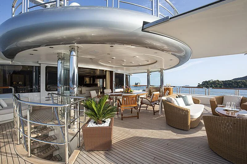 a patio with a table and chairs aboard FIREBIRD Yacht for Charter