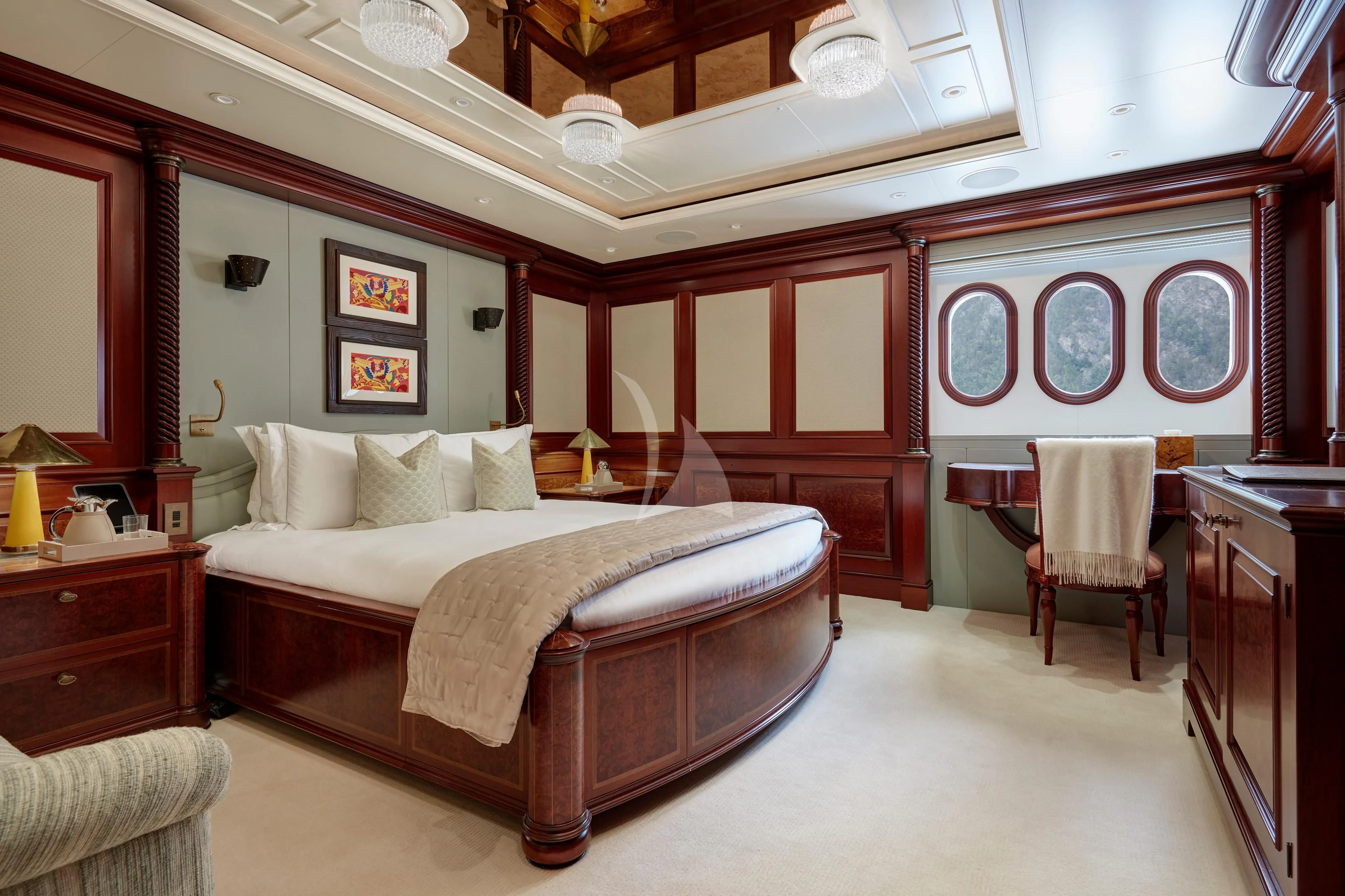 a bedroom with a bed and a chair aboard FIREBIRD Yacht for Charter