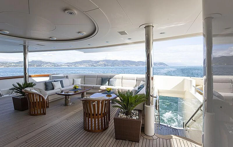 a patio with a table and chairs aboard FIREBIRD Yacht for Charter
