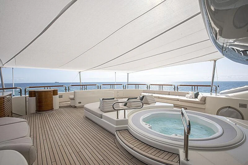 a large white lounge chair next to a pool aboard FIREBIRD Yacht for Charter
