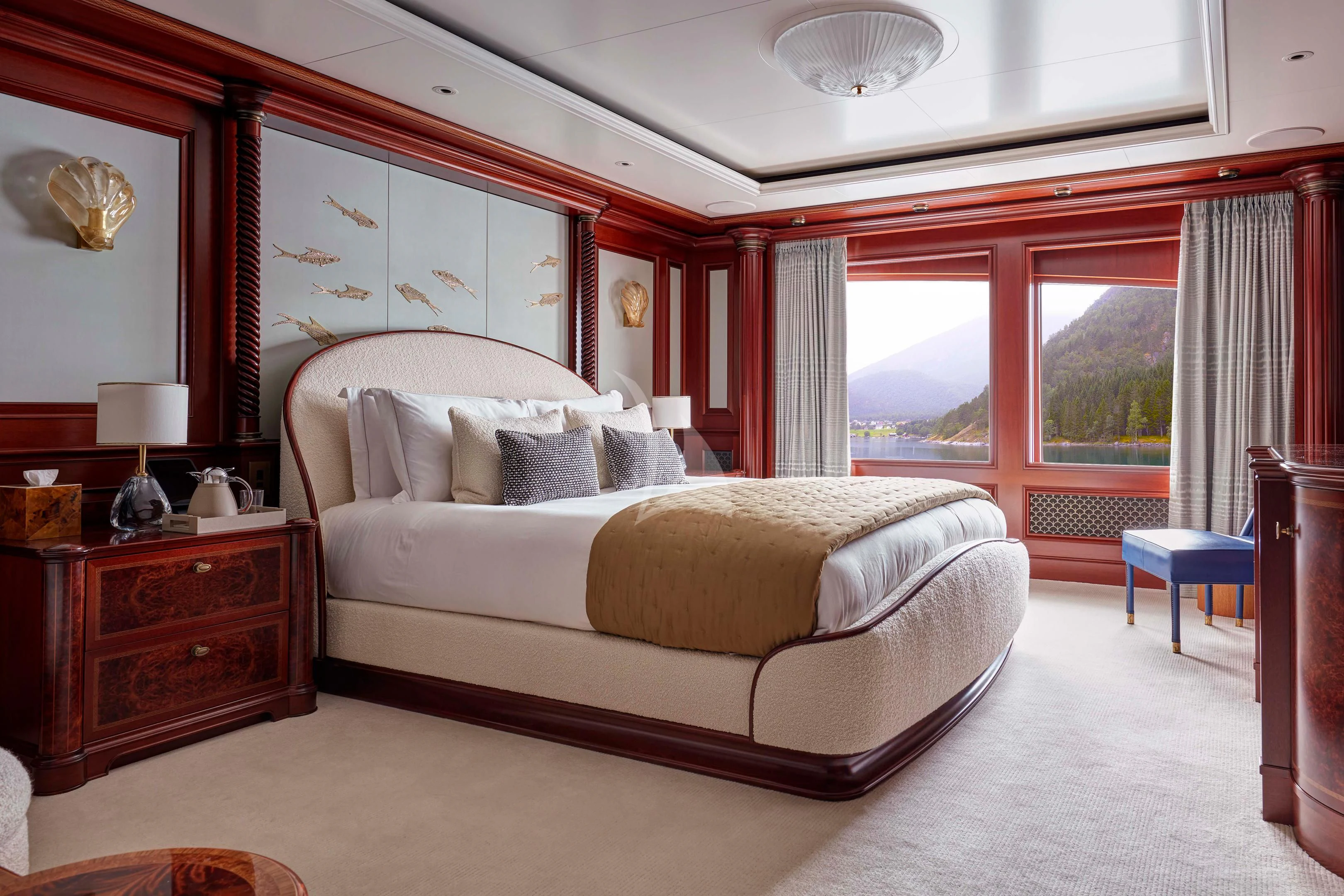 a bedroom with a bed and a window aboard FIREBIRD Yacht for Charter