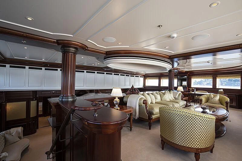 a large living room with a table and chairs aboard FIREBIRD Yacht for Charter