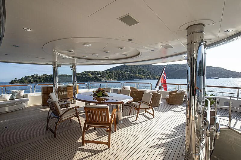 a table and chairs on a deck aboard FIREBIRD Yacht for Charter