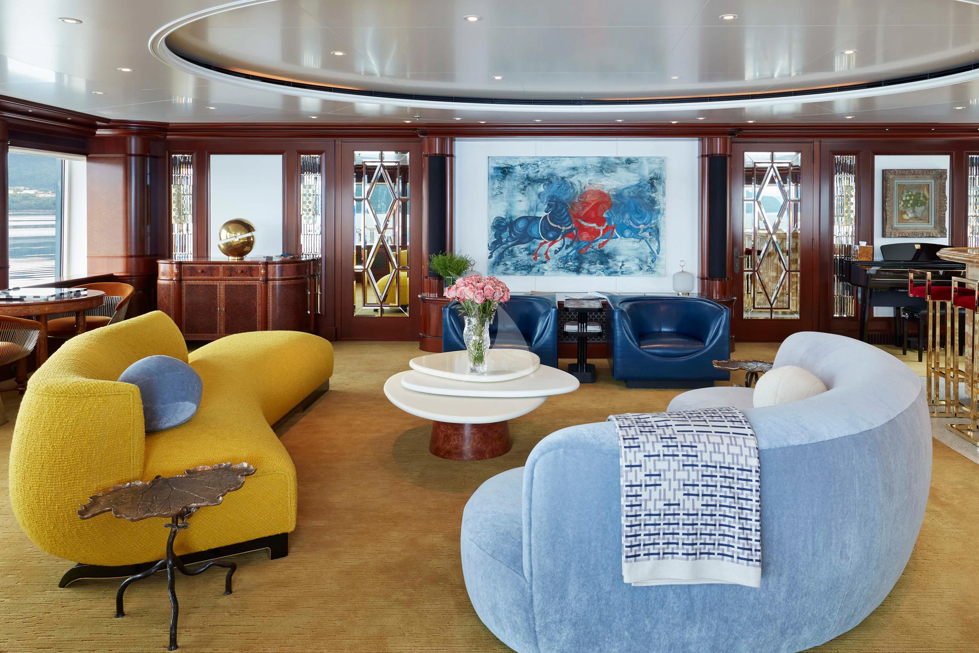 a living room with yellow furniture aboard FIREBIRD Yacht for Charter