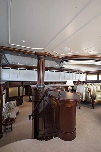 a large room with a table and chairs aboard FIREBIRD Yacht for Charter