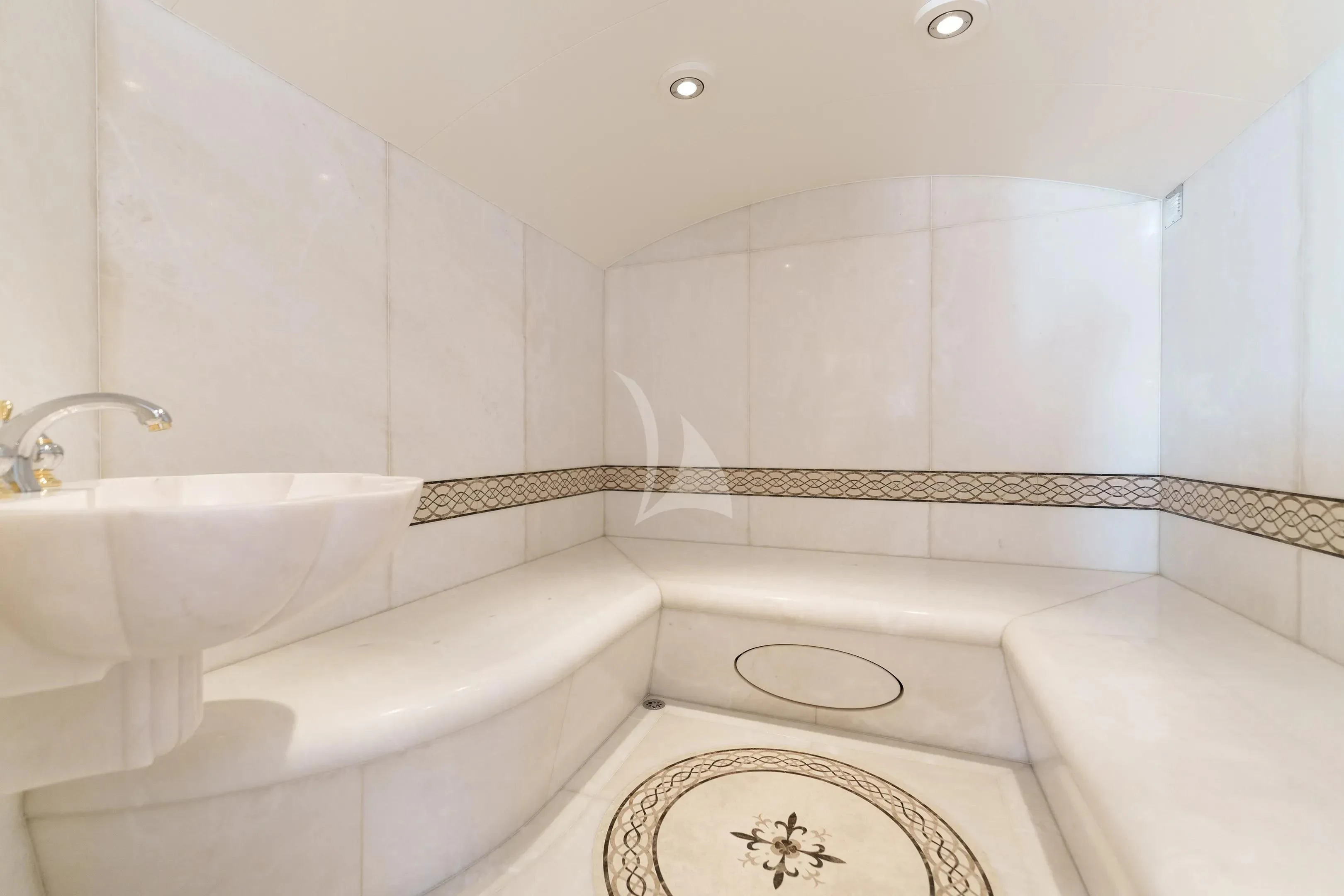 a bathroom with a sink and bathtub aboard FIREBIRD Yacht for Charter