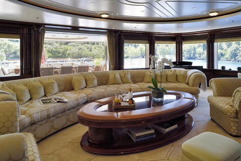 a living room with a table and couches aboard FIREBIRD Yacht for Charter