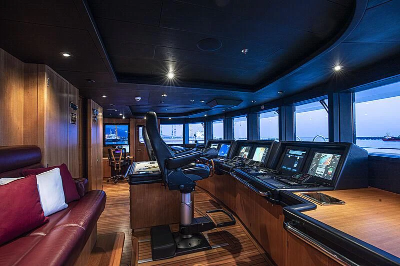 a room with a desk and a chair with computers on it aboard FIREBIRD Yacht for Charter