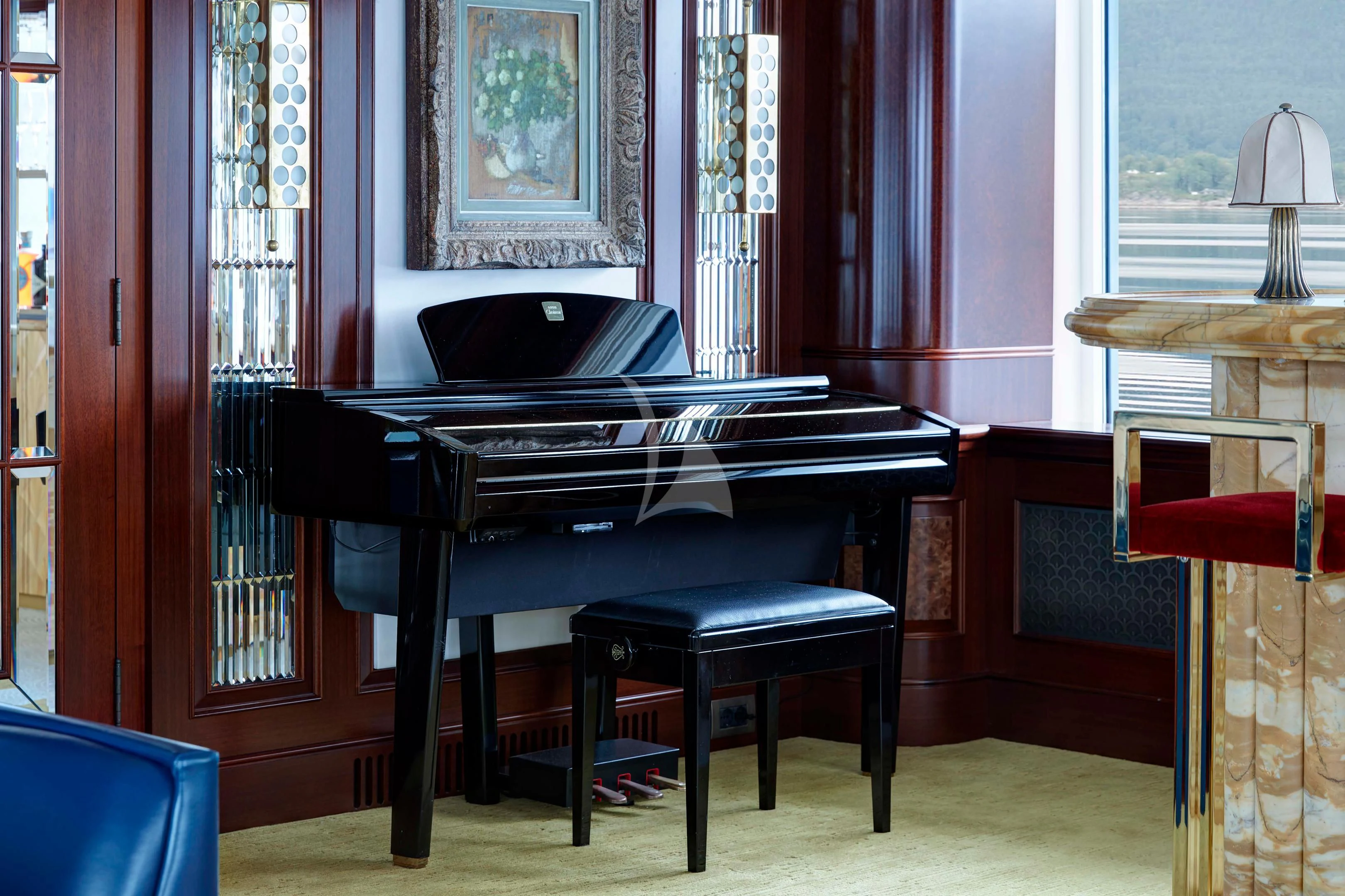 a piano in a room aboard FIREBIRD Yacht for Charter