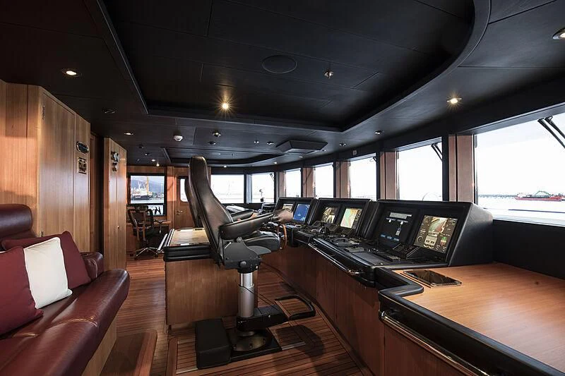 a room with a desk and chairs aboard FIREBIRD Yacht for Charter