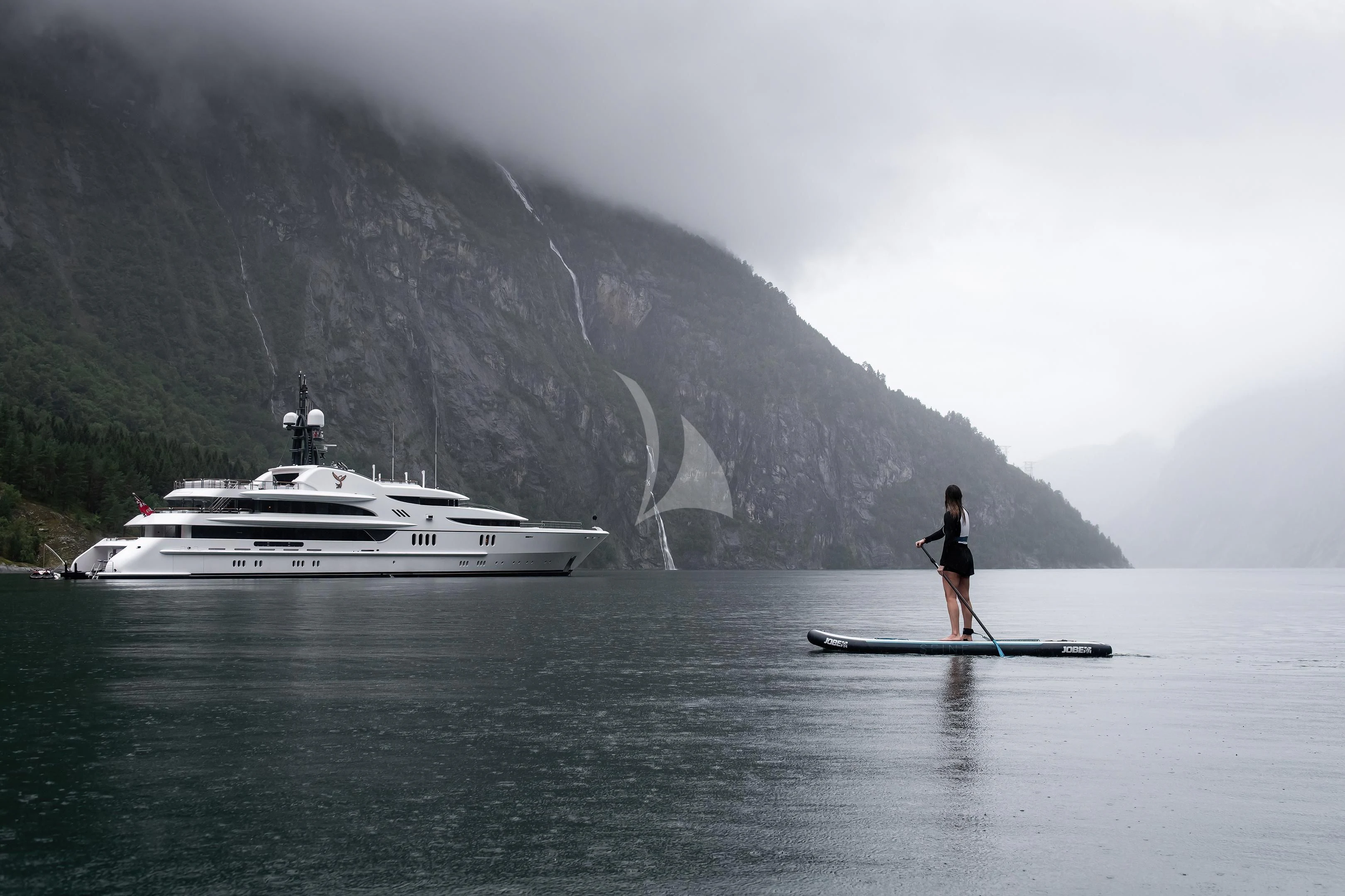 a person standing on a boat in the water aboard FIREBIRD Yacht for Charter