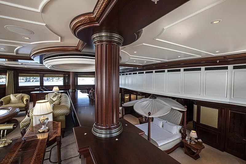 a room with a bed and a lamp aboard FIREBIRD Yacht for Charter