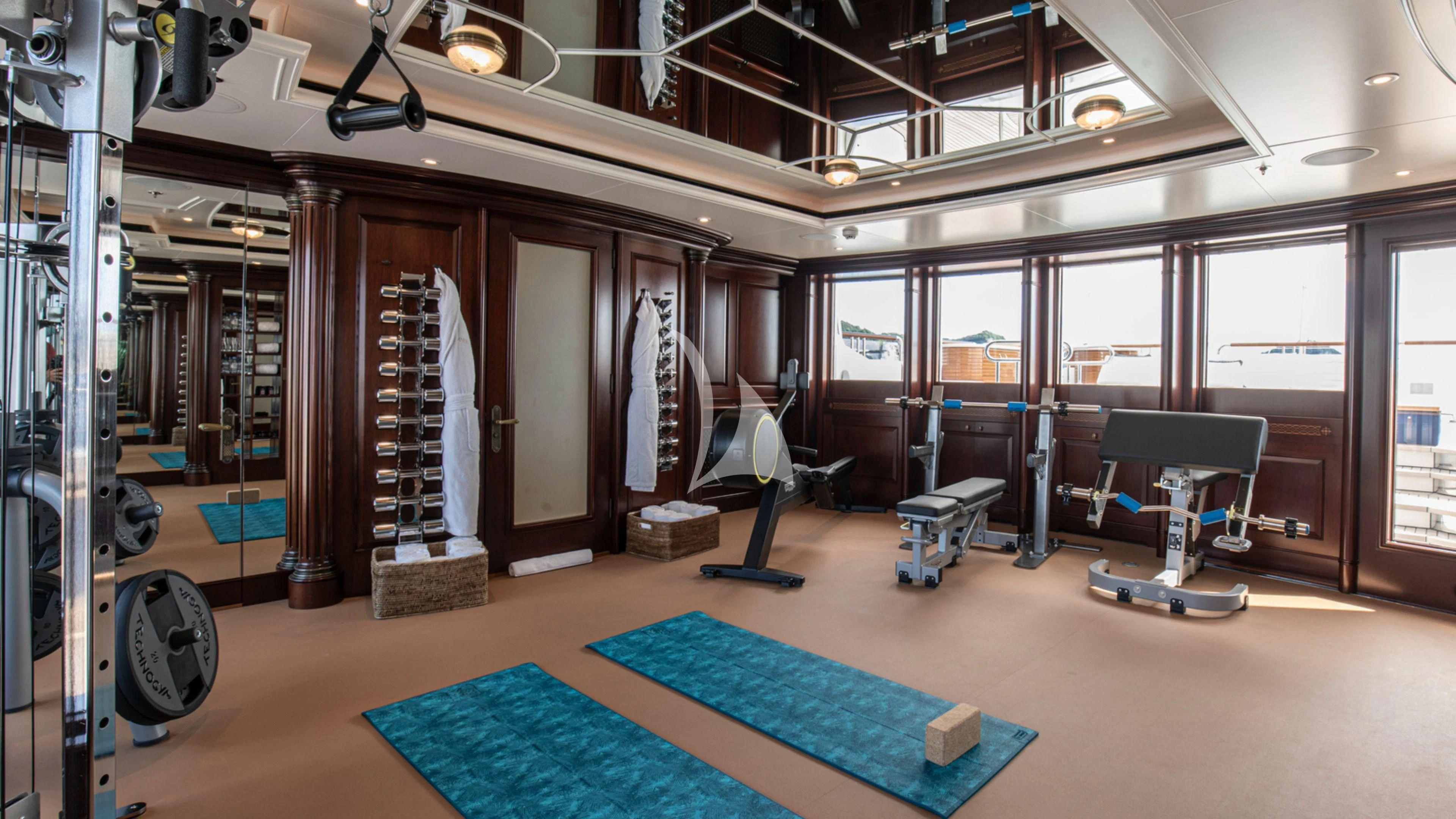 a gym with exercise equipment aboard FIREBIRD Yacht for Charter