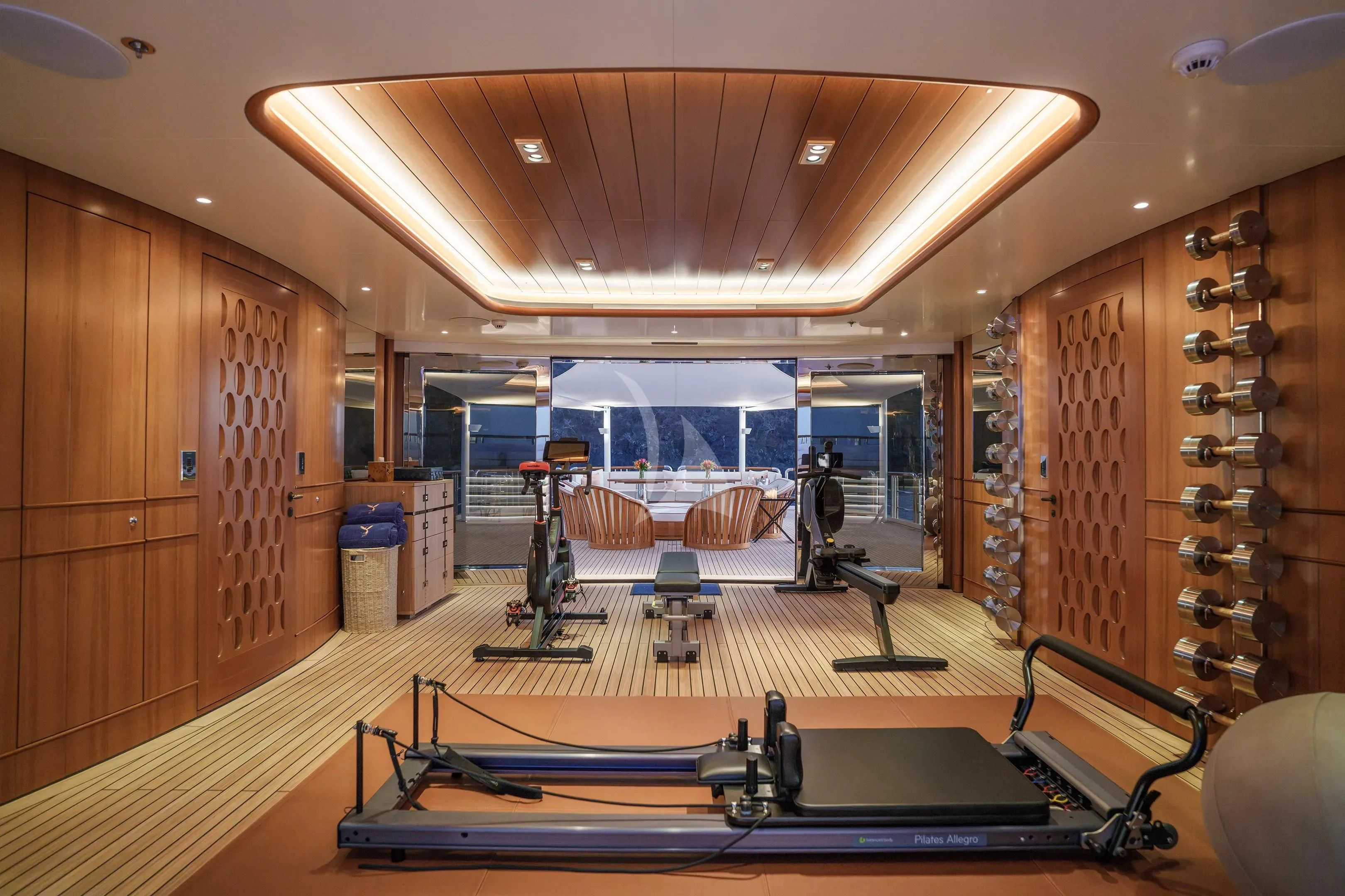 a room with a large mirror and a table with chairs aboard FIREBIRD Yacht for Charter