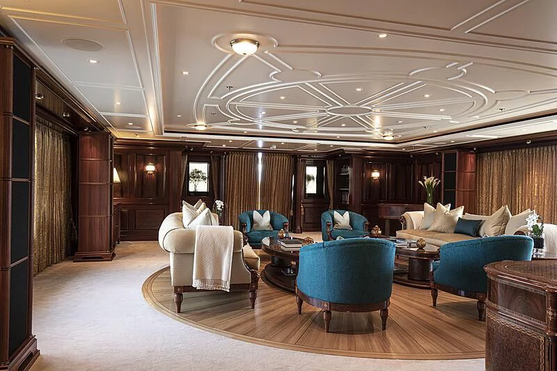 a large living room with a large chandelier aboard FIREBIRD Yacht for Charter