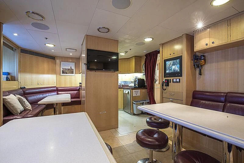 a large kitchen with a bar and bar area aboard FIREBIRD Yacht for Charter