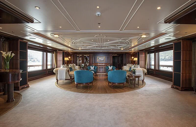 a large living room with a pool table and chairs aboard FIREBIRD Yacht for Charter