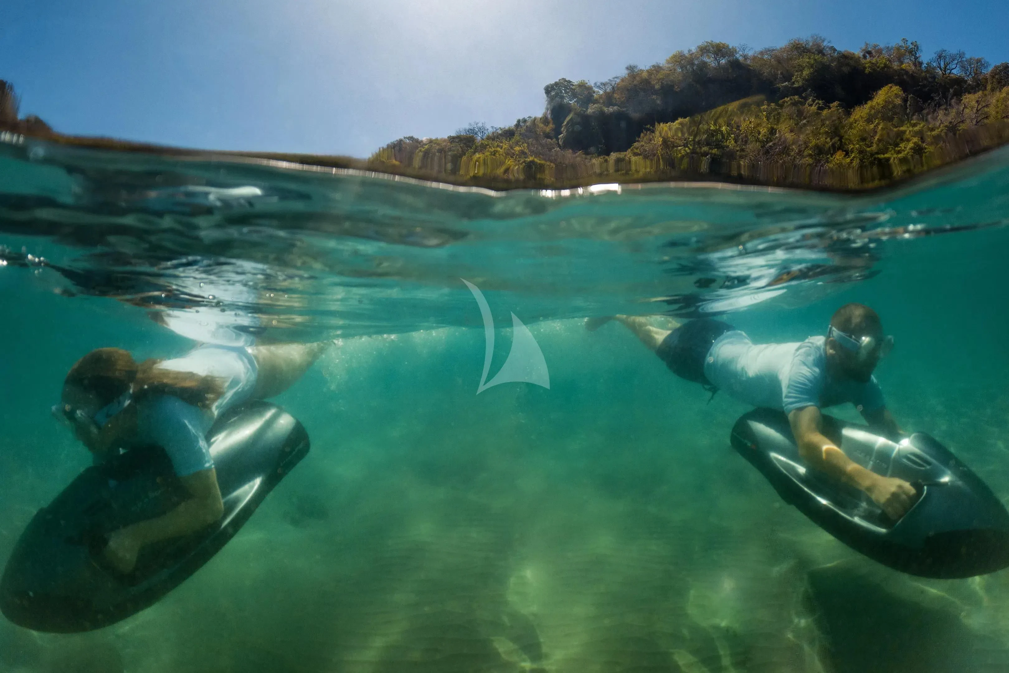 a group of people swimming in a body of water aboard FIREBIRD Yacht for Charter
