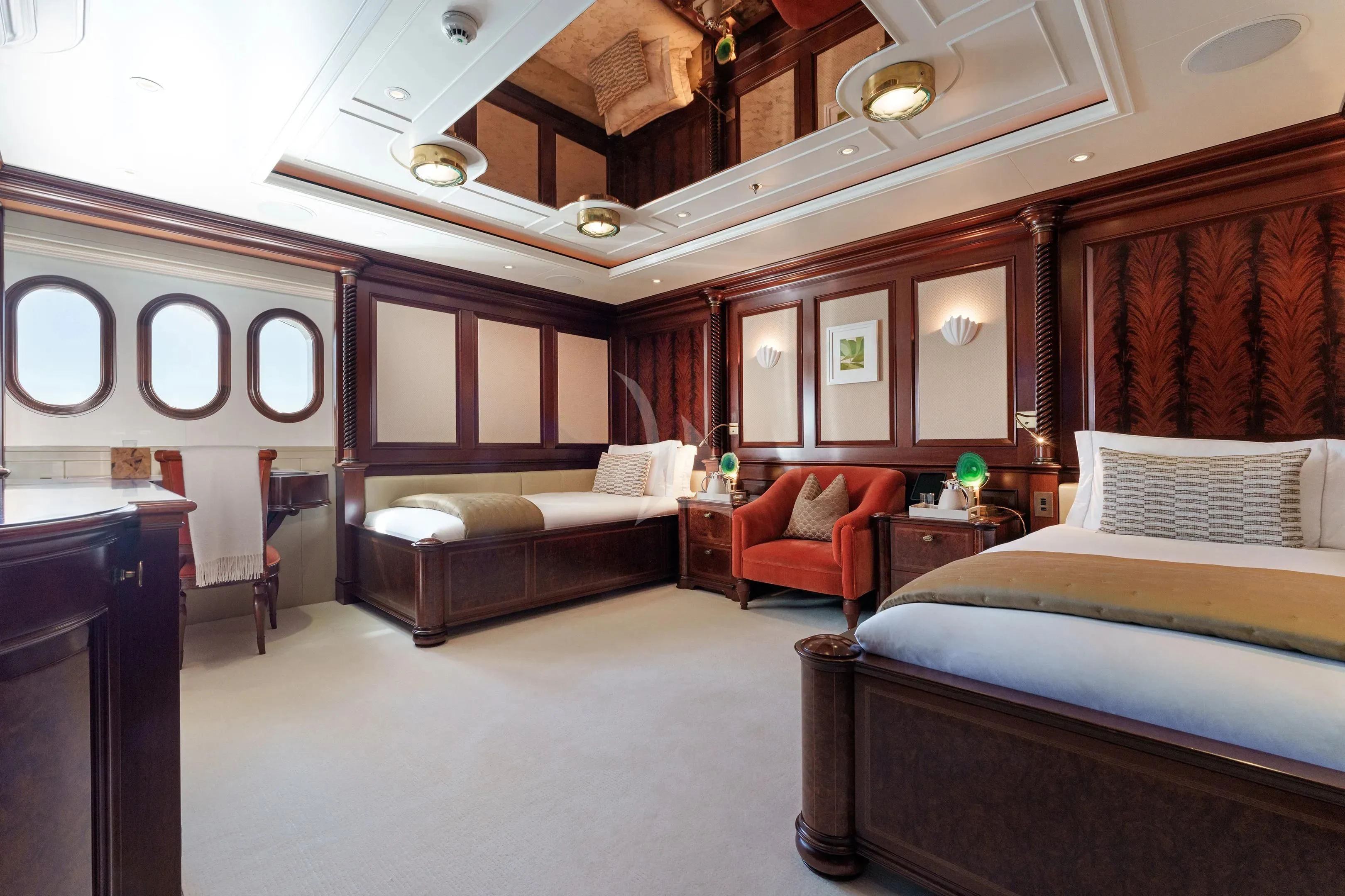 a room with a bed and a couch aboard FIREBIRD Yacht for Charter