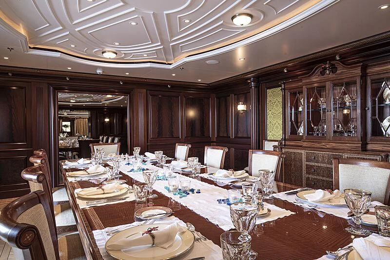 a large dining room with tables and chairs aboard FIREBIRD Yacht for Charter