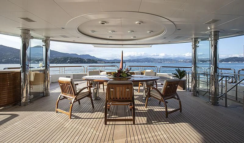 a table and chairs on a deck aboard FIREBIRD Yacht for Charter