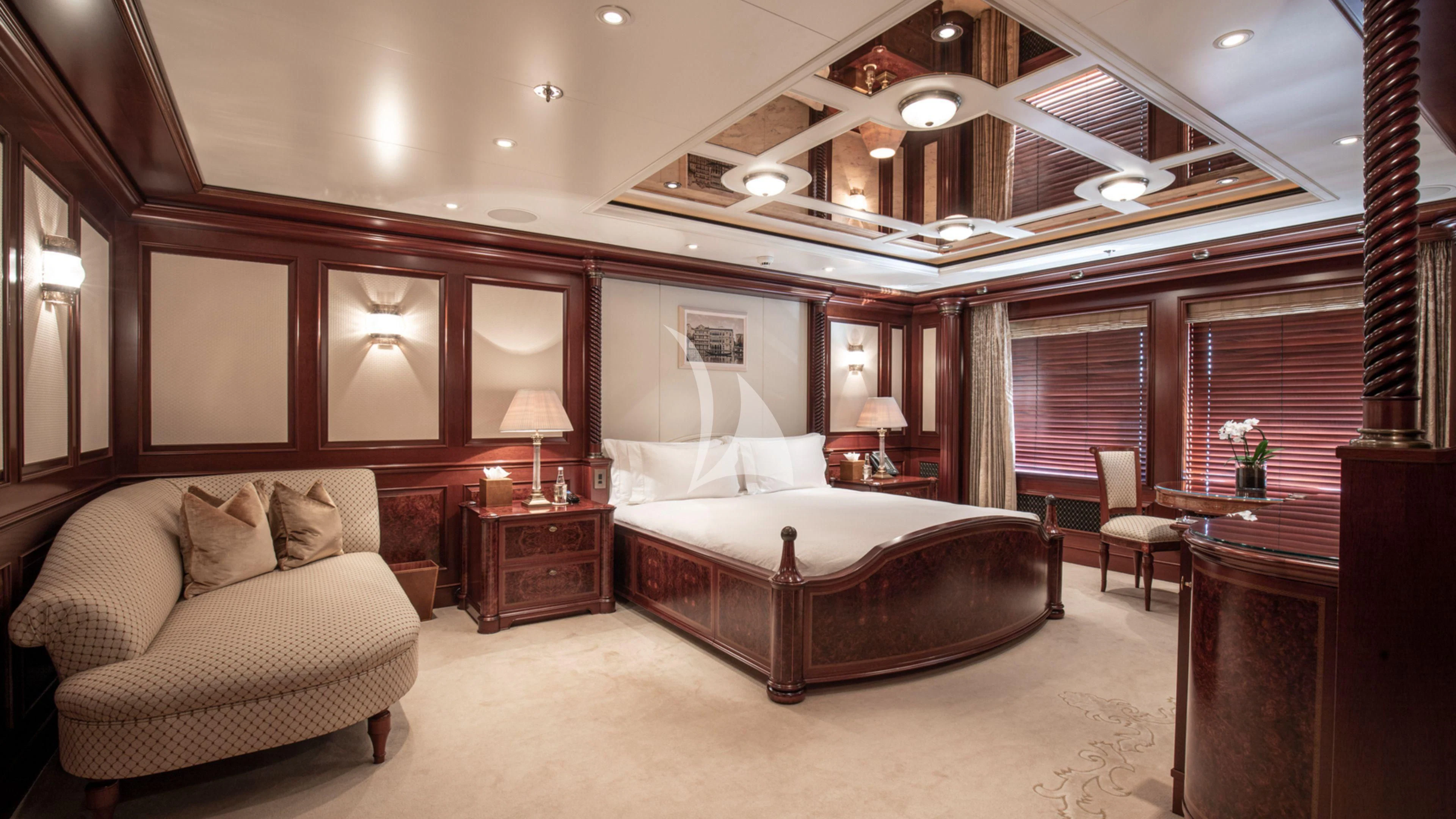 a large bedroom with a bed and a couch aboard FIREBIRD Yacht for Charter