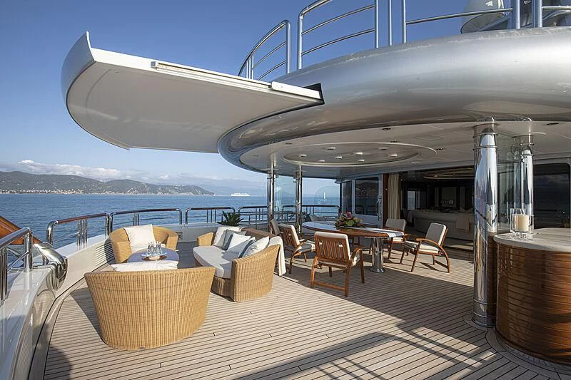 a table and chairs on a deck aboard FIREBIRD Yacht for Charter