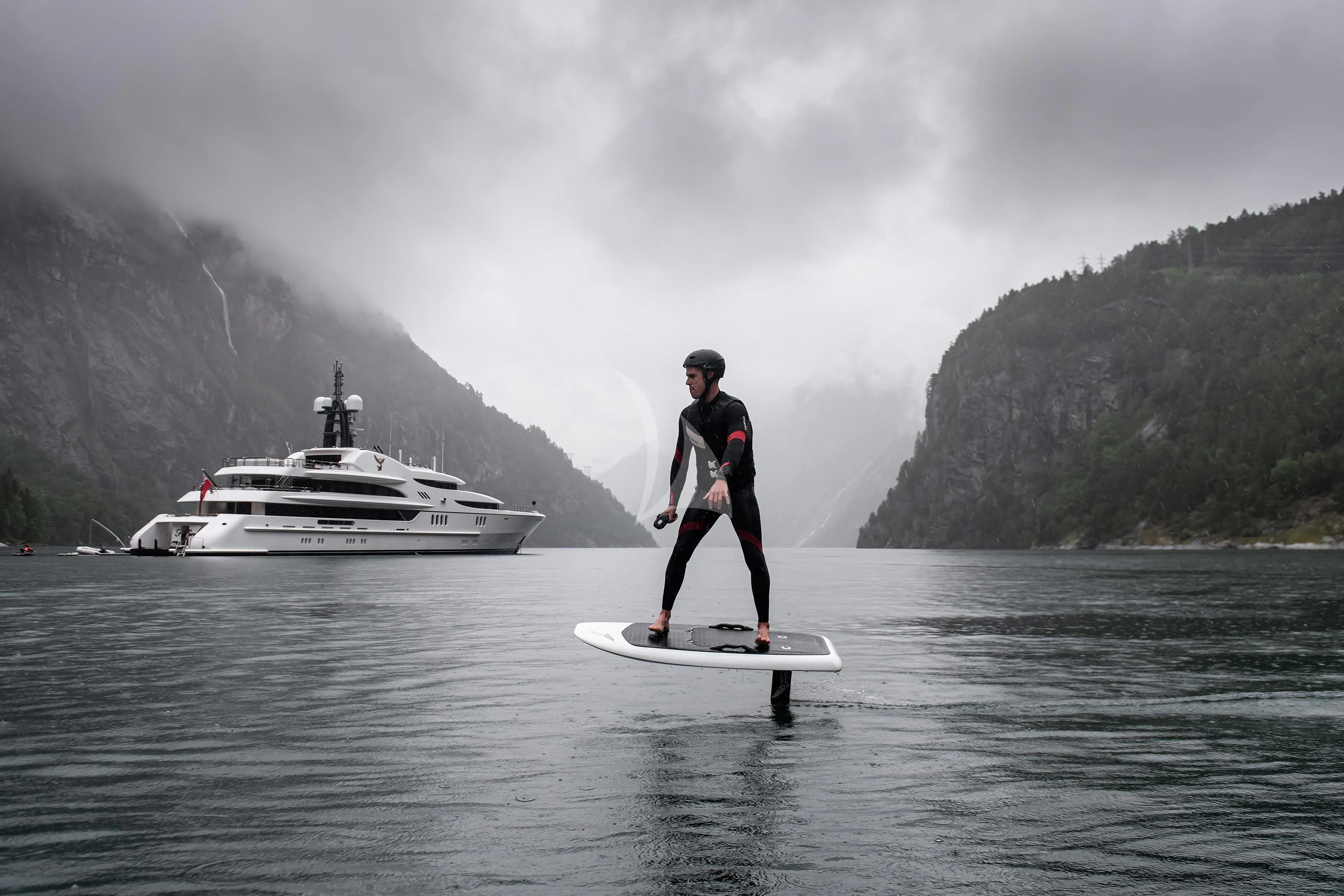 a man on a surfboard in the water aboard FIREBIRD Yacht for Charter