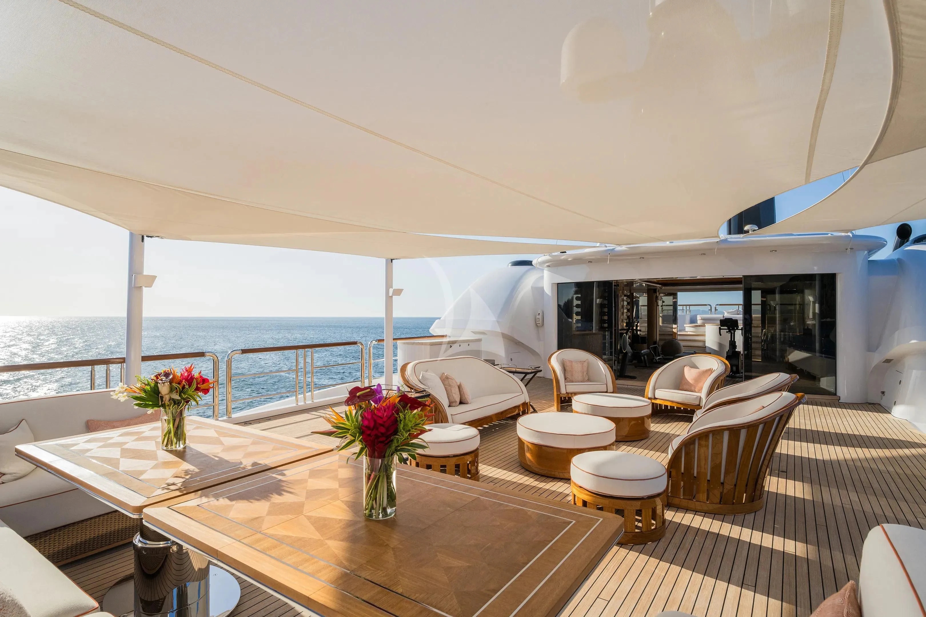 a room with a table chairs and flowers on the table aboard FIREBIRD Yacht for Charter