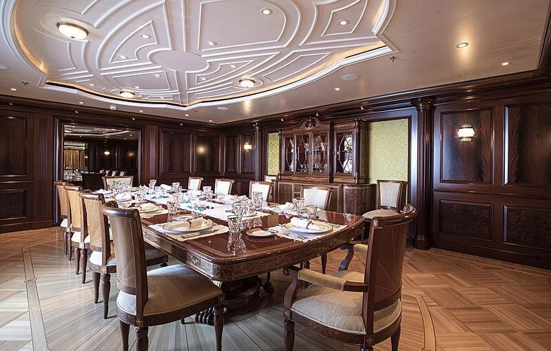 a dining room with a table and chairs aboard FIREBIRD Yacht for Charter