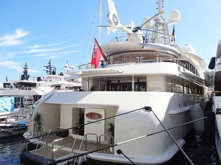 a large white boat in a harbor aboard FIREBIRD Yacht for Charter